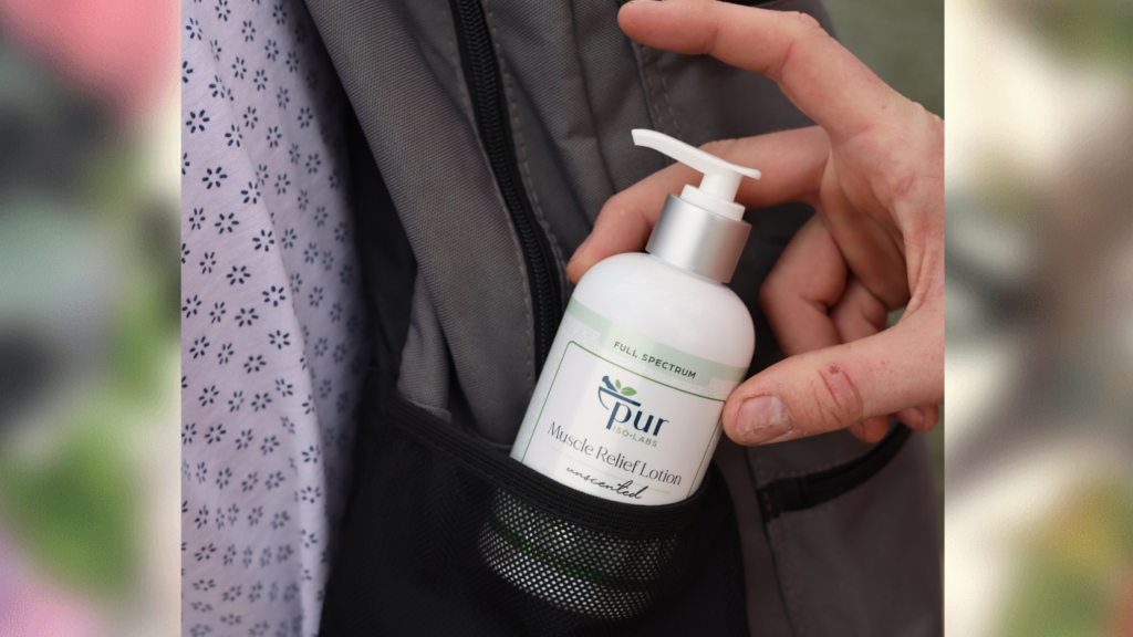hand pulling out Pur IsoLabs lotion from backpack