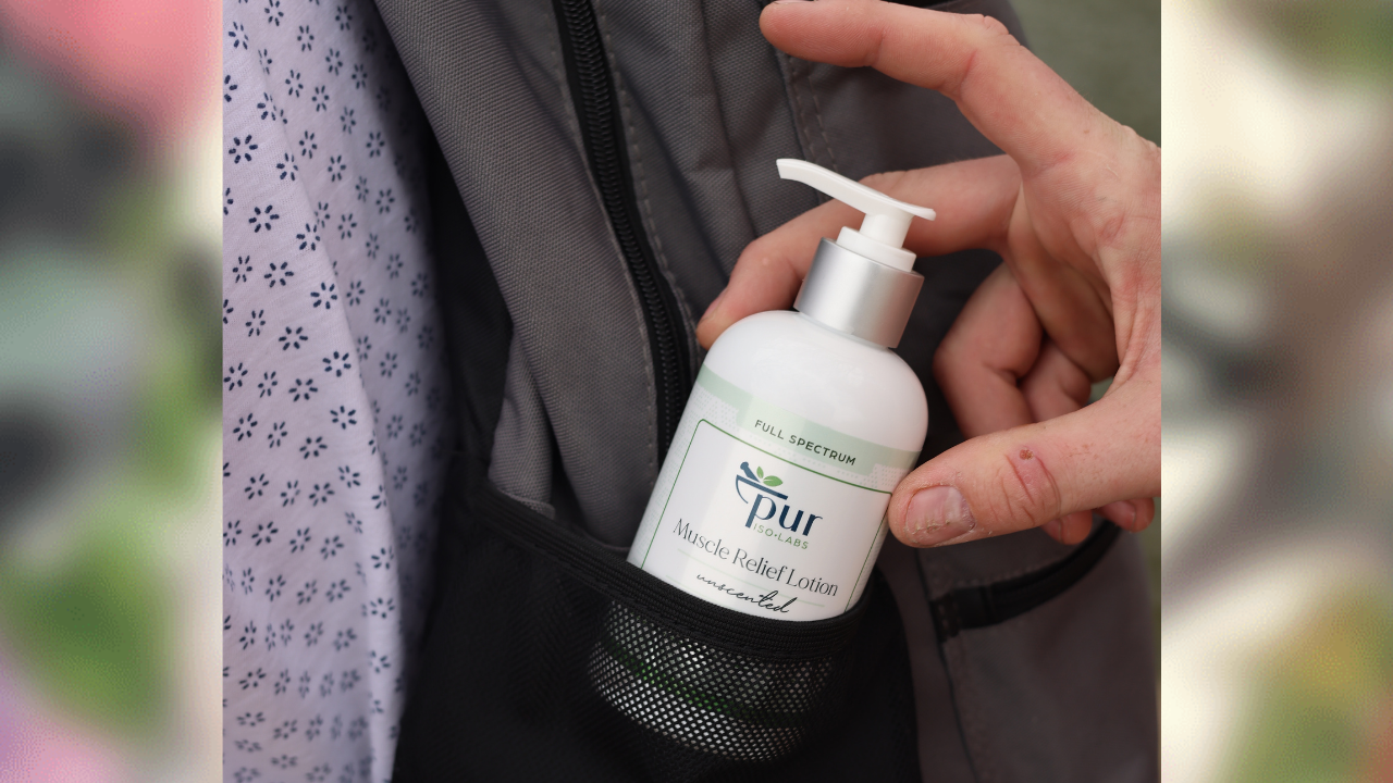 hand pulling out Pur IsoLabs lotion from backpack
